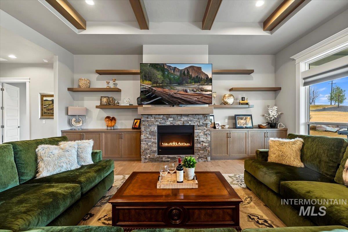 15465 Syrah Court Caldwell, ID 83607 - Photo 7 of 50 Living room with recessed lighting, light wood-style floors, a fireplace, and beamed ceiling
