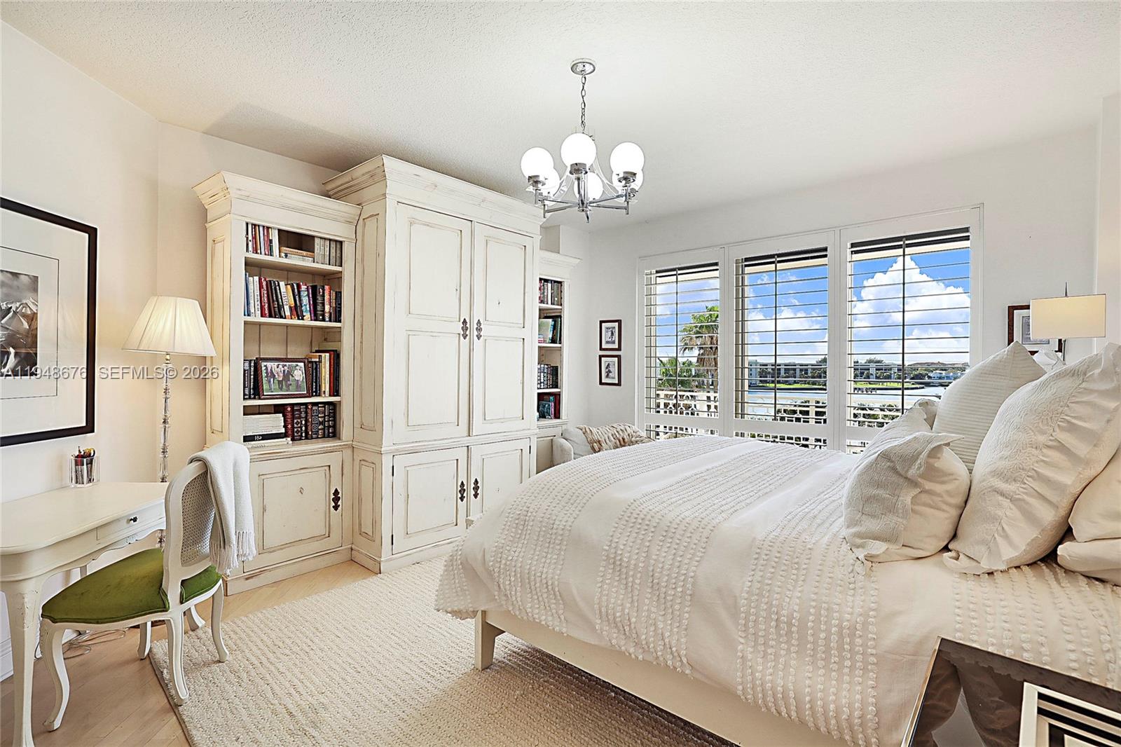 19950 South Beach Road, Unit 4S Jupiter, FL 33469 - Photo 17 of 56 a spacious bedroom with a bed and a large window