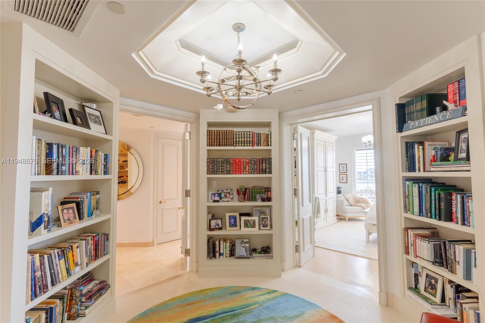 19950 South Beach Road, Unit 4S Jupiter, FL 33469 - Photo 20 of 56 a living room with furniture and a book shelf