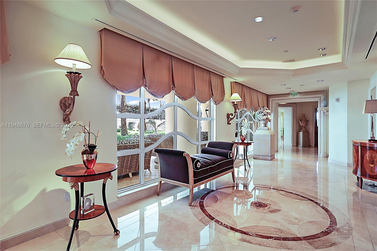 19950 South Beach Road, Unit 4S Jupiter, FL 33469 - Photo 39 of 56 a living room with furniture a piano and a chandelier