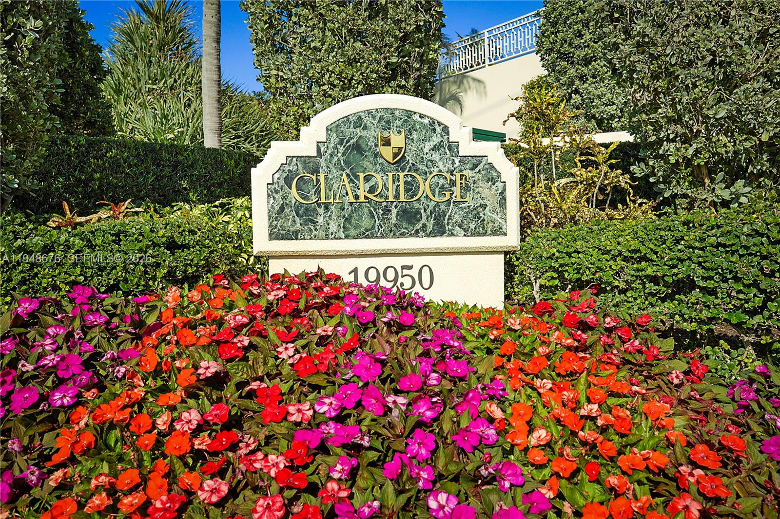 19950 South Beach Road, Unit 4S Jupiter, FL 33469 - Photo 56 of 56 a sign that is sitting in front of flowers
