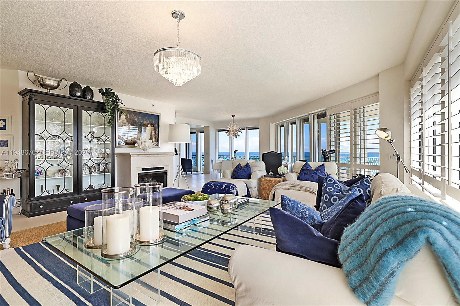 19950 South Beach Road, Unit 4S Jupiter, FL 33469 - Photo 8 of 56 a living room with fireplace furniture and a large window