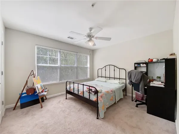 a bedroom with bed and a window