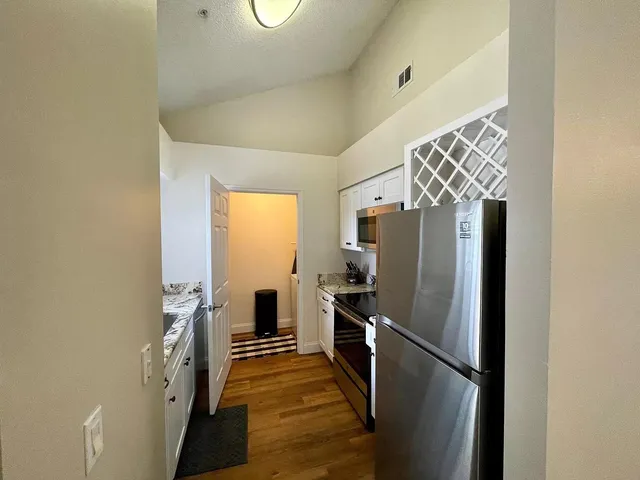 a kitchen with stainless steel appliances a refrigerator and a stove