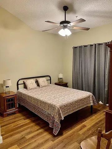 a bedroom with a bed and ceiling fan