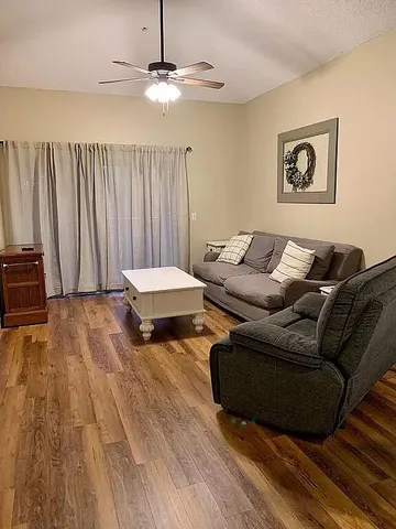 a living room with couches and chandelier