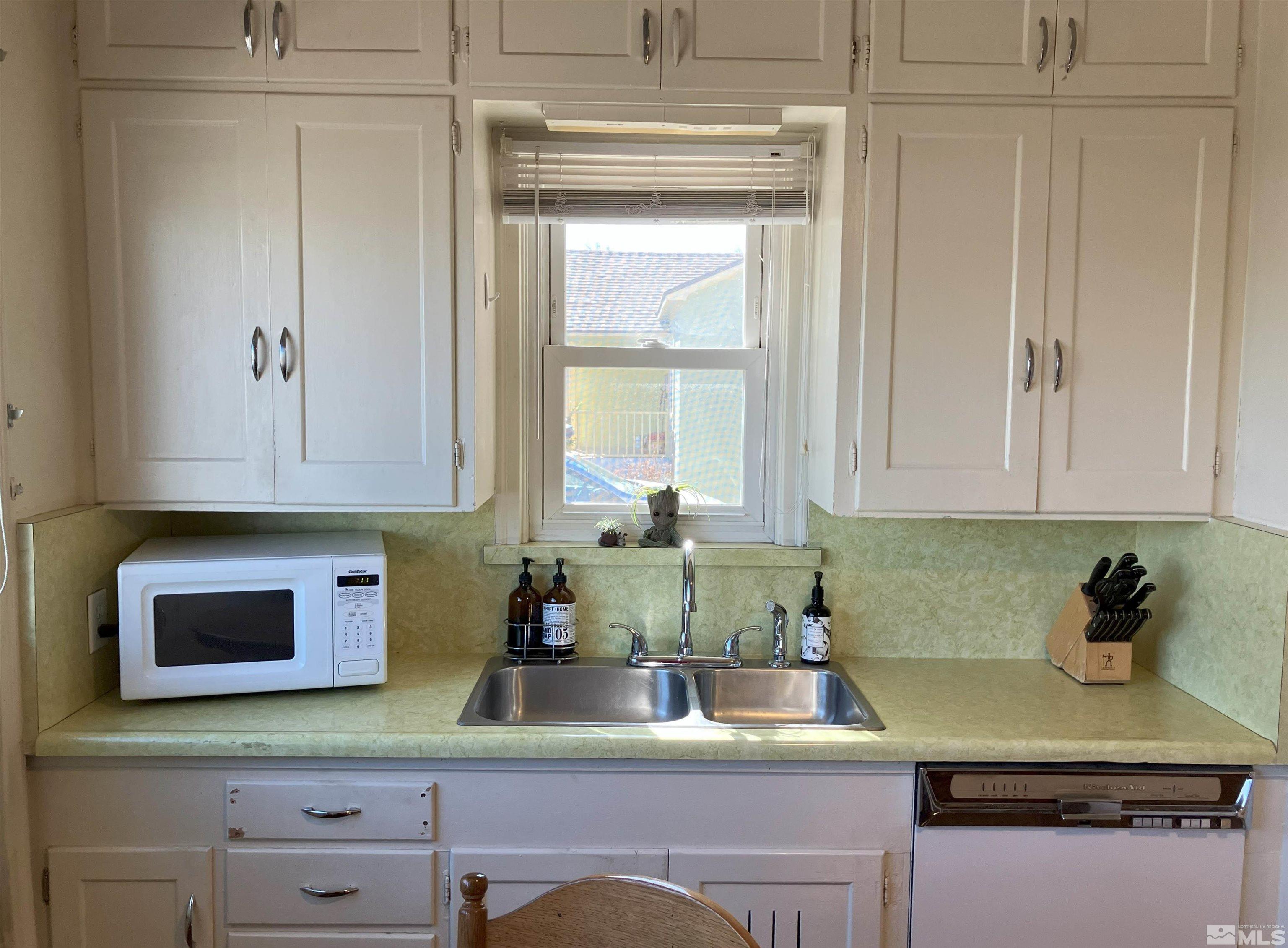 1663 Ordway Avenue Reno, NV 89509 - Photo 3 of 20 a kitchen with stainless steel appliances granite countertop a sink a stove and cabinets