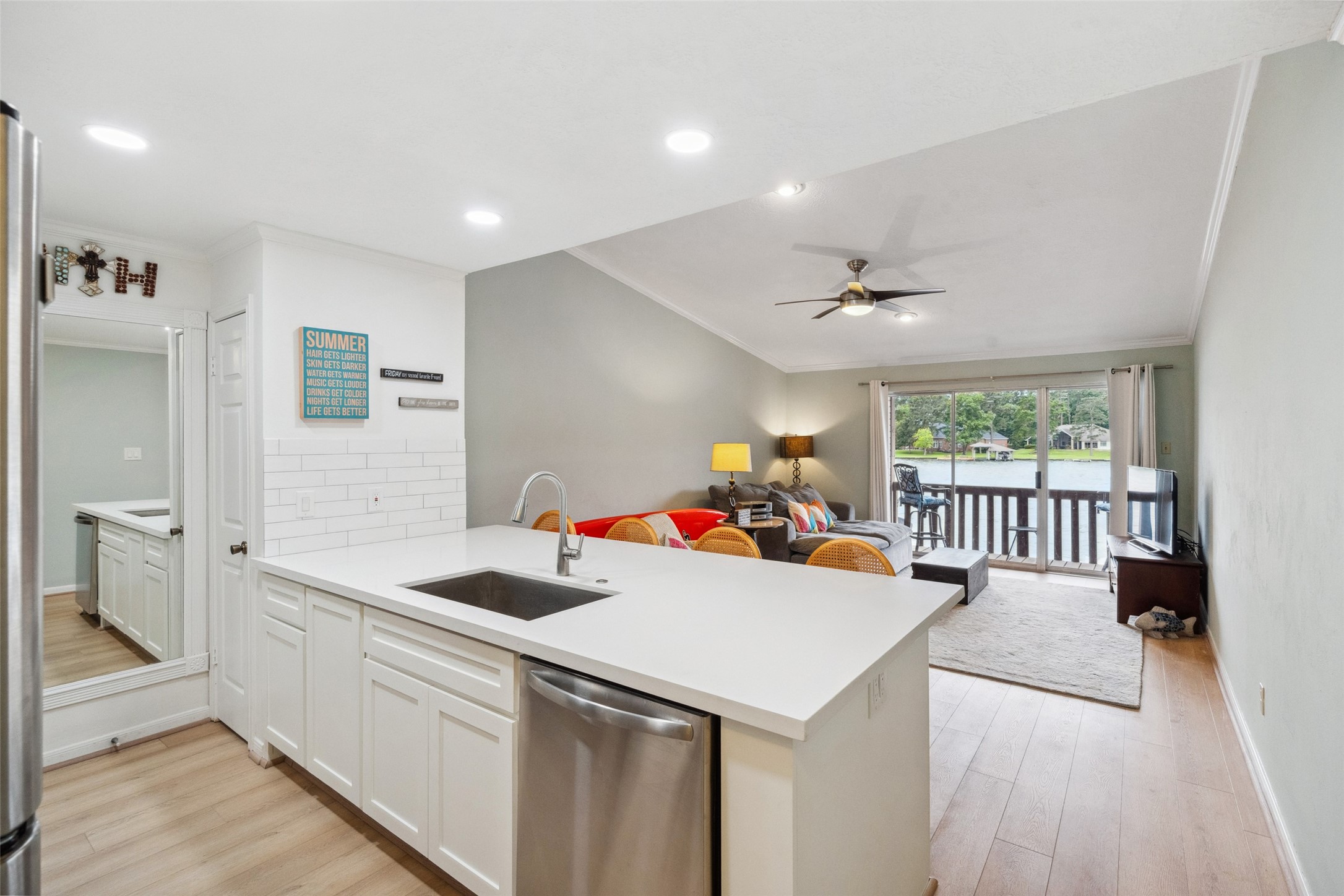 801 River Road, Unit F120 Montgomery, TX 77356 - Photo 5 of 18 Open Concept design allows for 24/7 great waterfront views. Spotless, updated Kitchen includes Refrigerator/Range/Dishwasher. Washer/Dryer Hookups in kitchen. Pantry to the Right of Mirror. 801 River Rd., #F120, Montgomery.