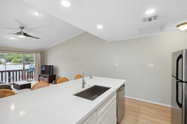 a kitchen with stainless steel appliances a refrigerator stove microwave and sink