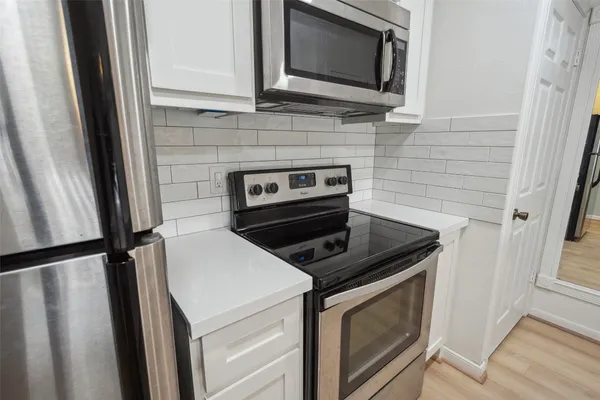 a kitchen with stainless steel appliances a refrigerator stove microwave and sink