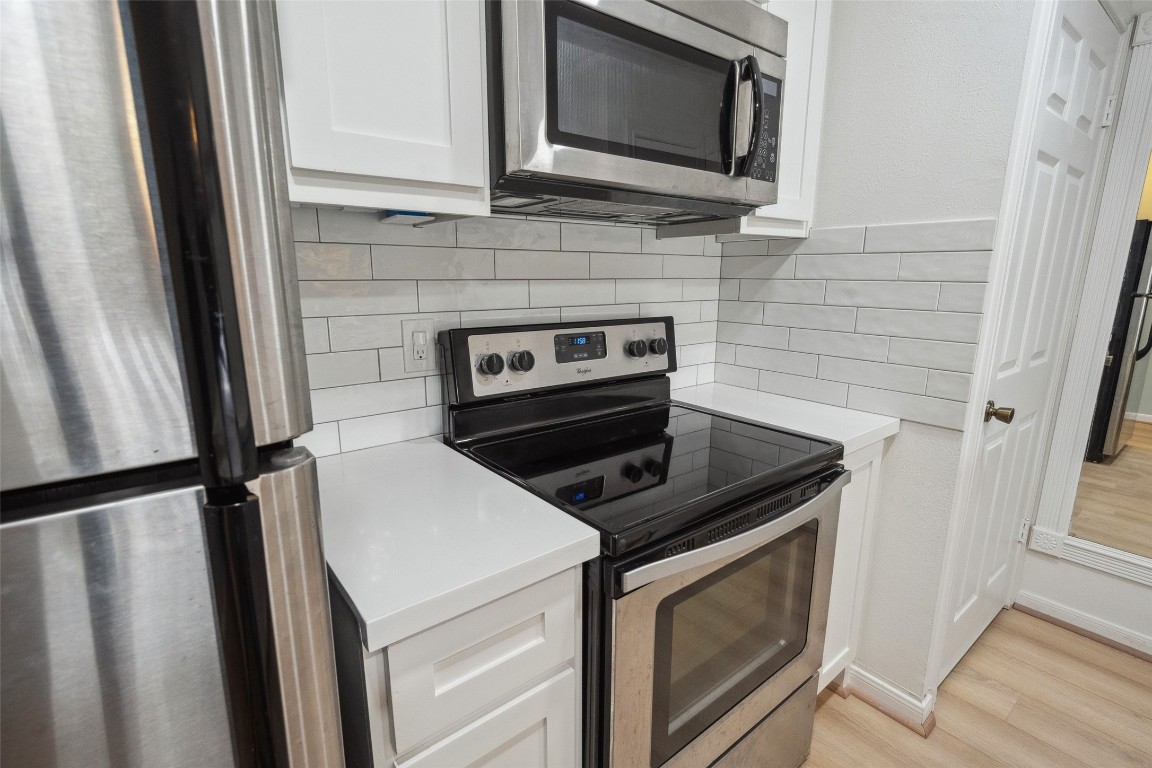 801 River Road, Unit F120 Montgomery, TX 77356 - Photo 8 of 18 a kitchen with a stove microwave and sink