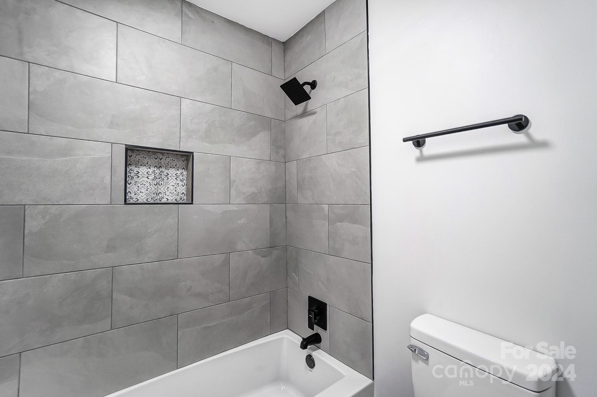 6524 Eaglecrest Road Charlotte, NC 28212 - Photo 25 of 48 a bathroom with a shower a toilet and a shower