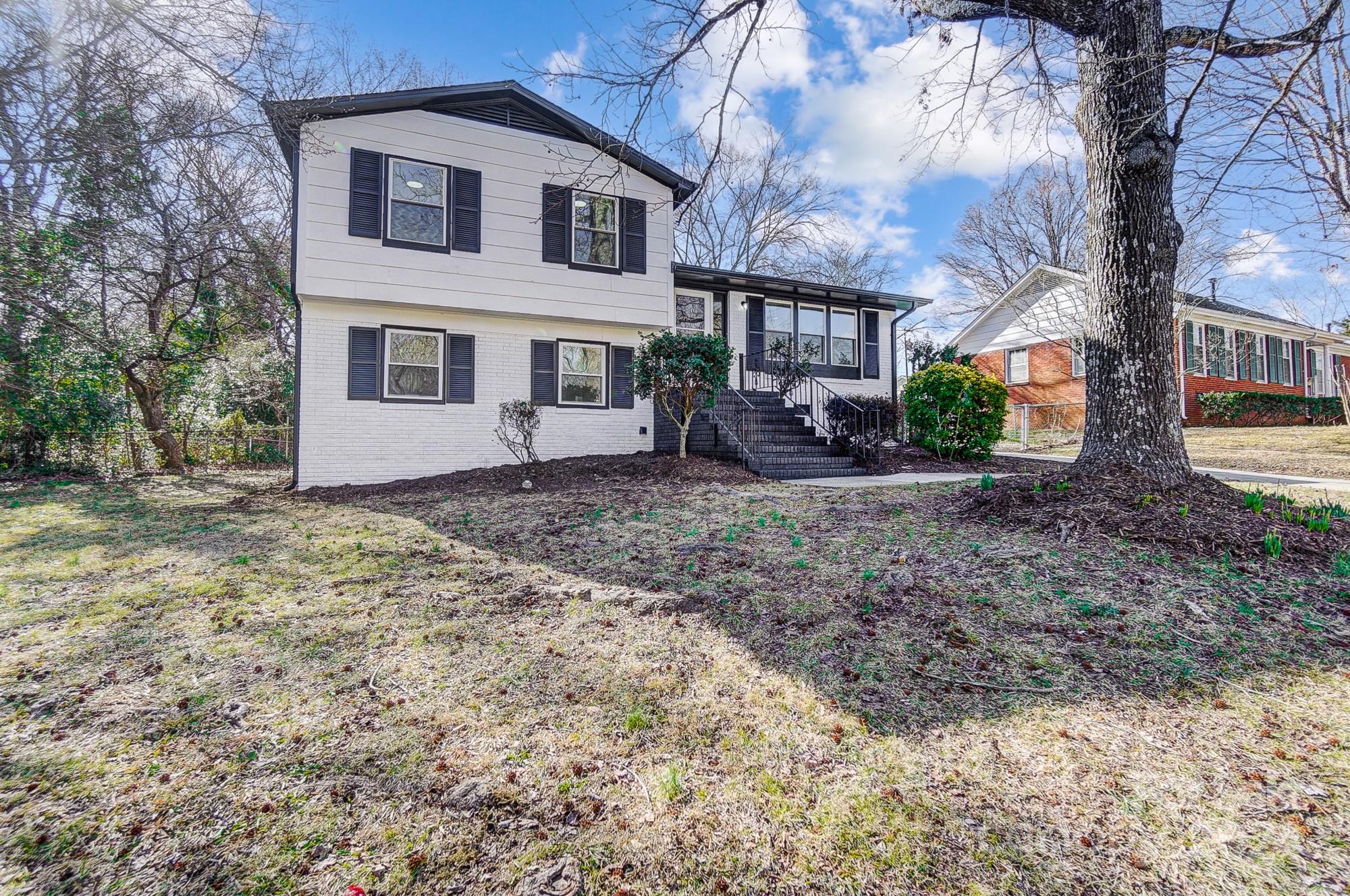 6524 Eaglecrest Road Charlotte, NC 28212 - Photo 3 of 48 a white house that has a tree in front of it