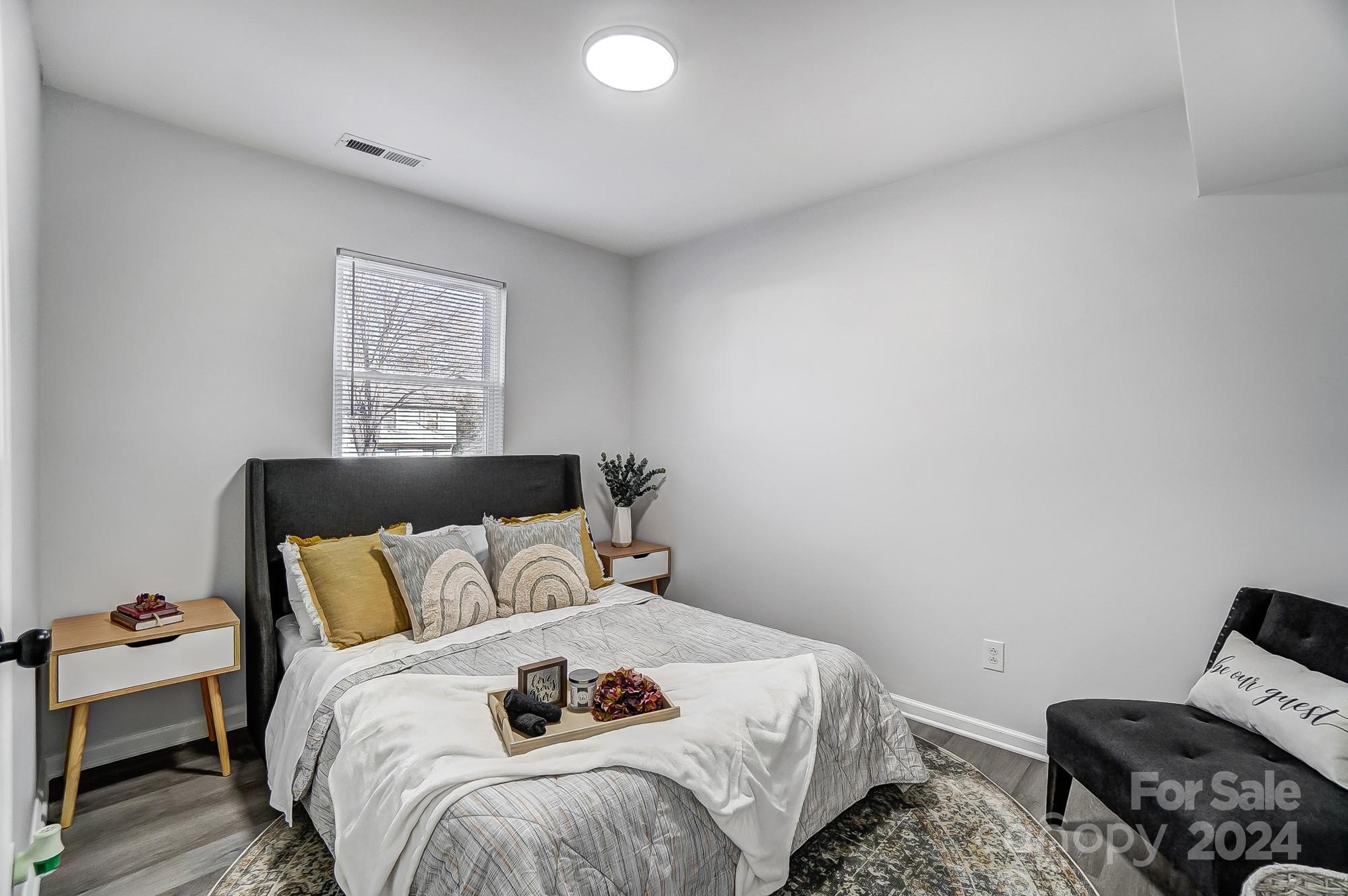 6524 Eaglecrest Road Charlotte, NC 28212 - Photo 32 of 48 a bedroom with a bed and wooden floor