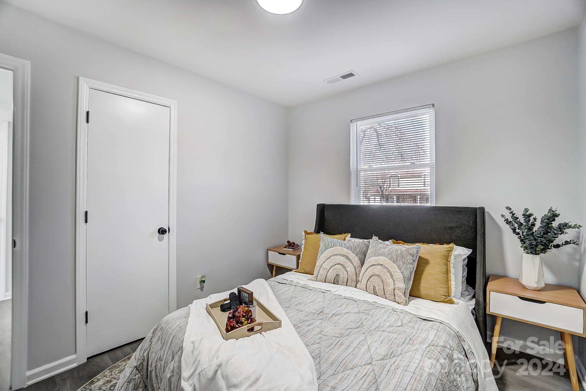 6524 Eaglecrest Road Charlotte, NC 28212 - Photo 33 of 48 a bedroom with a bed and a painting on the wall