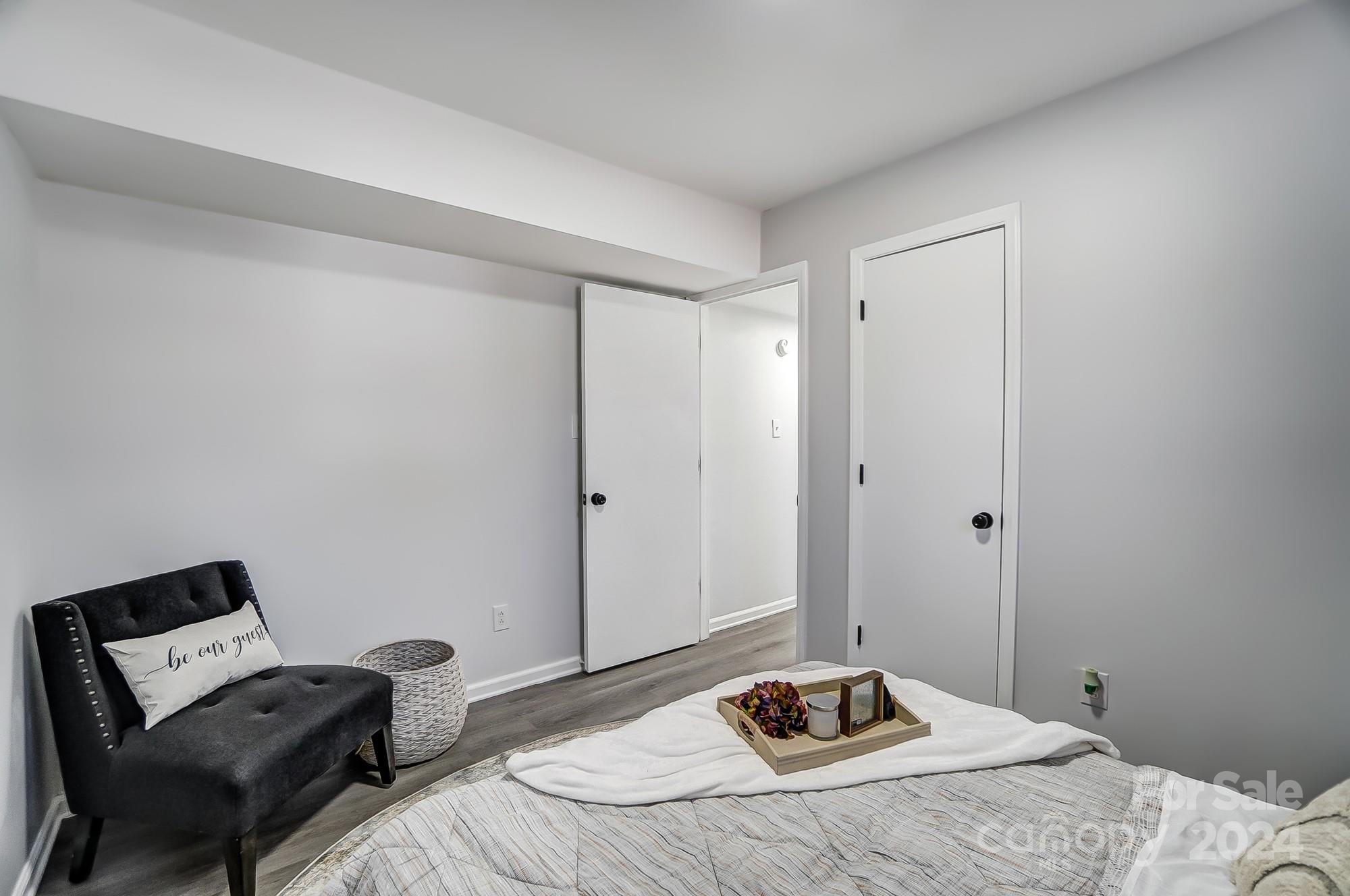 6524 Eaglecrest Road Charlotte, NC 28212 - Photo 34 of 48 a bedroom with a bed and a chair