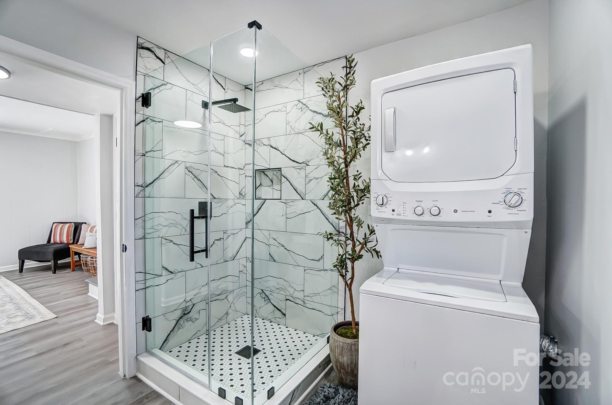 6524 Eaglecrest Road Charlotte, NC 28212 - Photo 36 of 48 a bathroom with a shower a toilet and a mirror