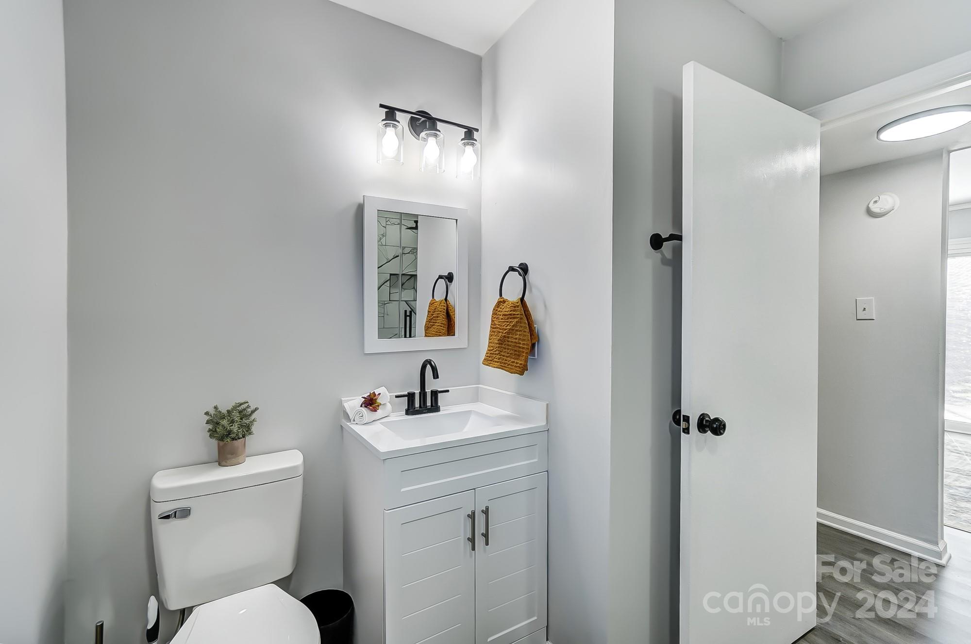 6524 Eaglecrest Road Charlotte, NC 28212 - Photo 37 of 48 a bathroom with a toilet sink and mirror