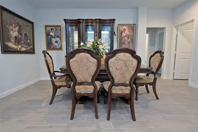a dining room with furniture and window