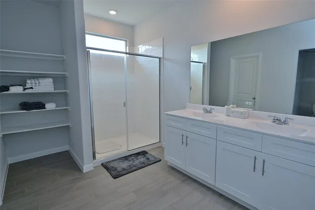 a bathroom with a double vanity sink a and a mirror
