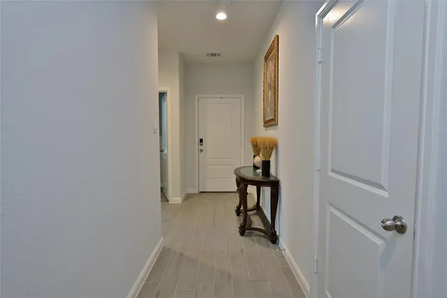 a view of a room with wooden floor