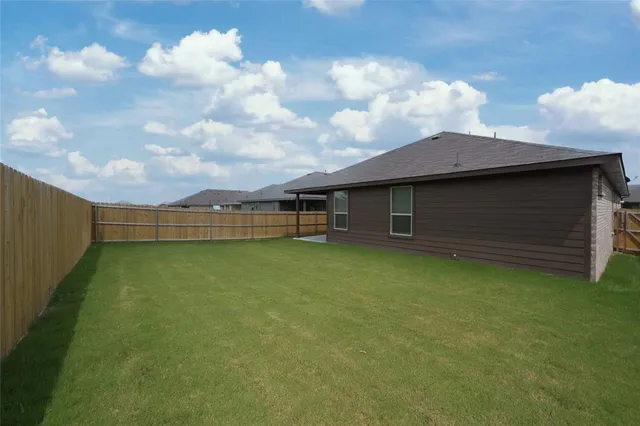 a view of a house with a backyard