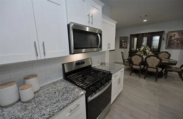 a kitchen with a stove and a microwave