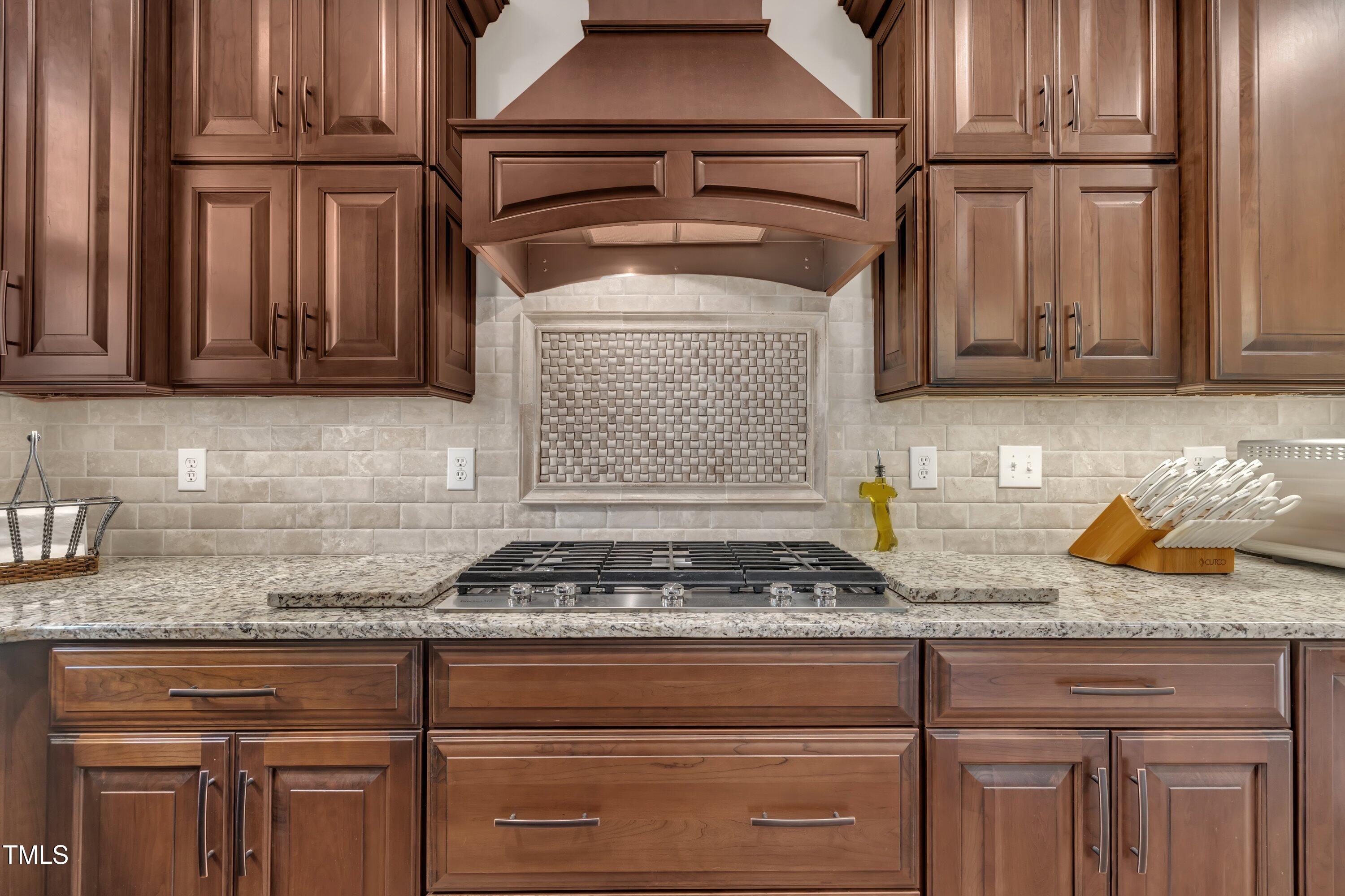 4802 Glenmist Court Raleigh, NC 27612 - Photo 12 of 52 a kitchen with granite countertop a stove and cabinets