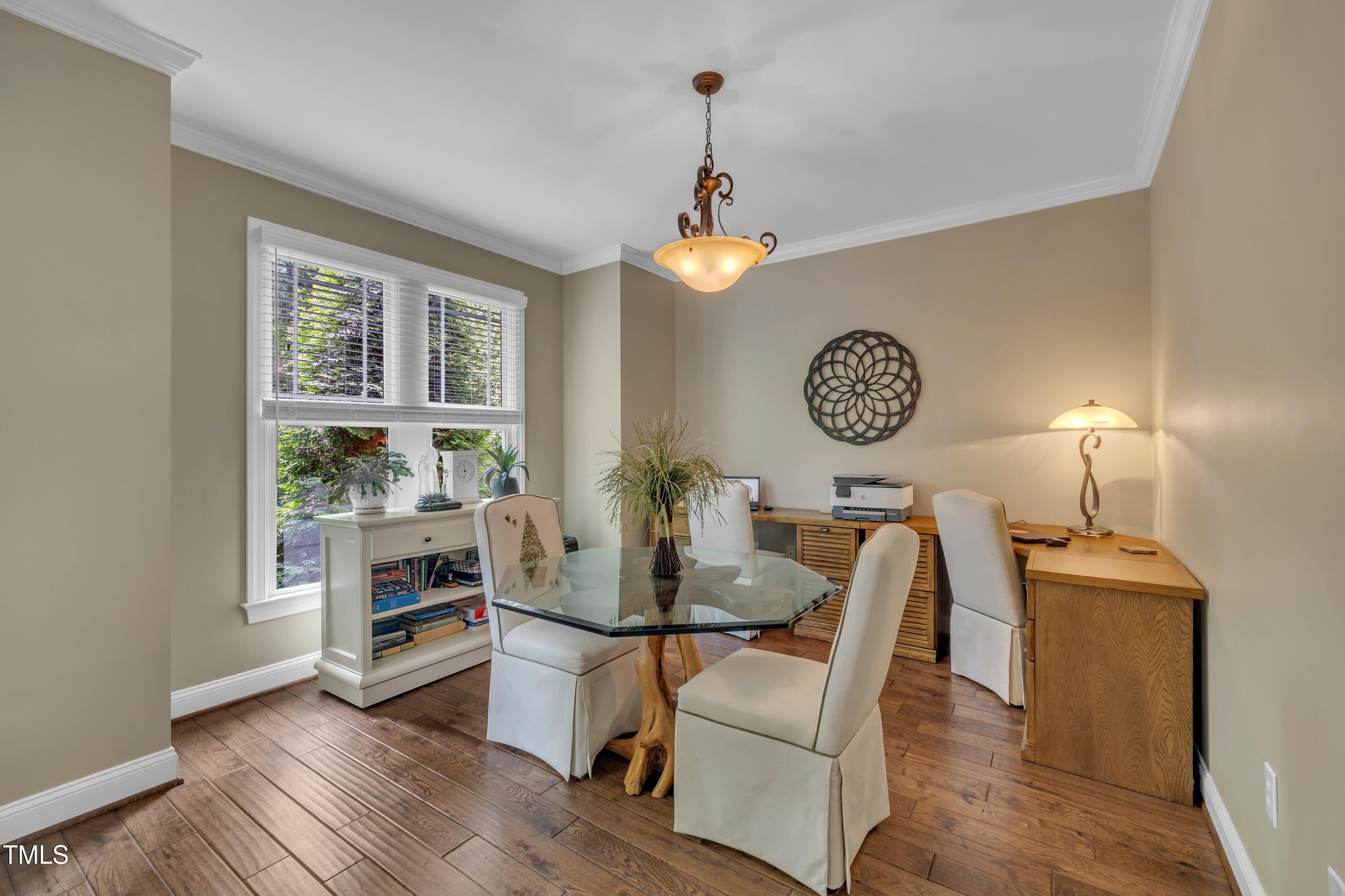 4802 Glenmist Court Raleigh, NC 27612 - Photo 18 of 52 a view of a dining room with furniture window and wooden floor