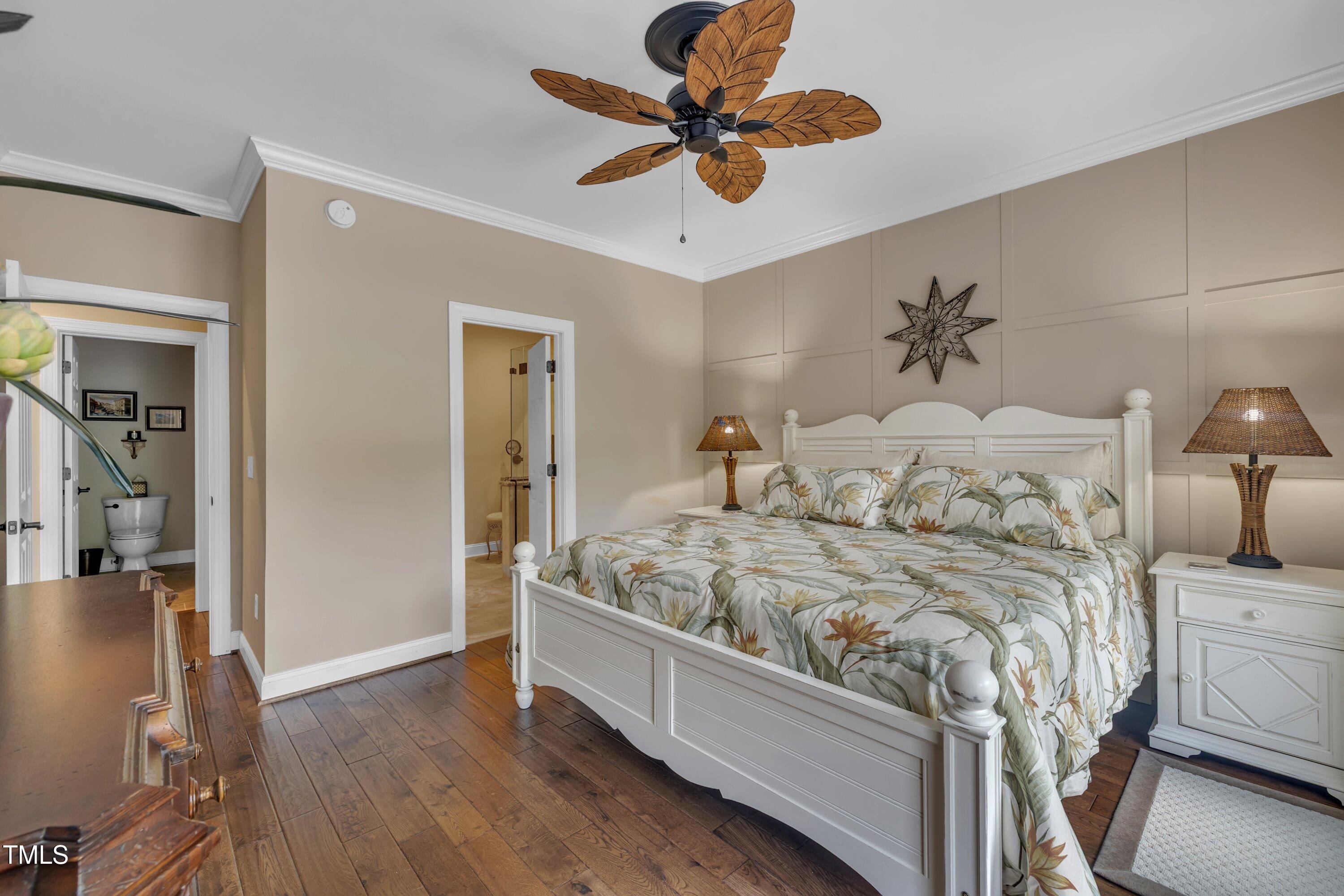 4802 Glenmist Court Raleigh, NC 27612 - Photo 22 of 52 a bedroom with a bed and a chandelier