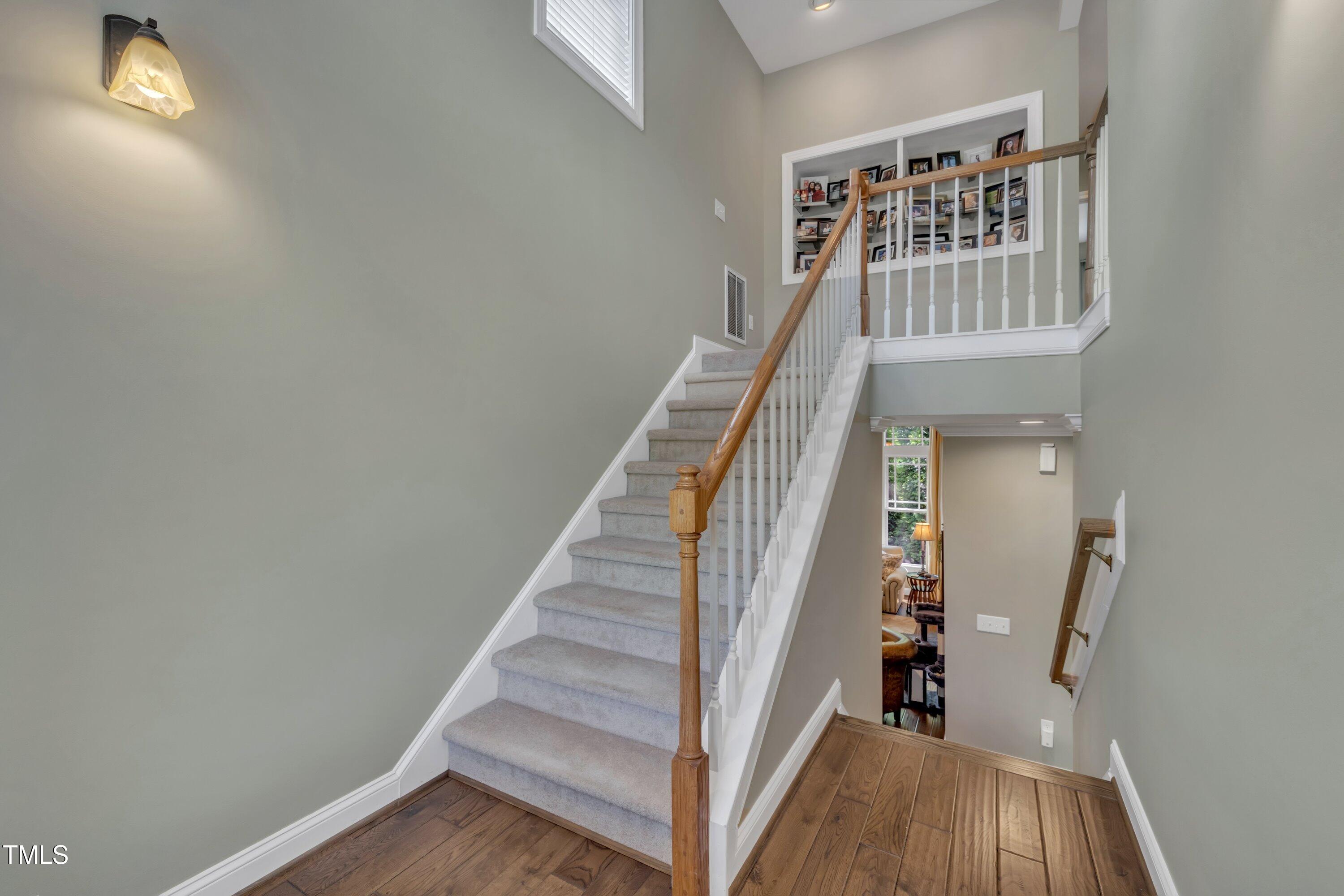 4802 Glenmist Court Raleigh, NC 27612 - Photo 27 of 52 a view of entryway with wooden floor and stairs