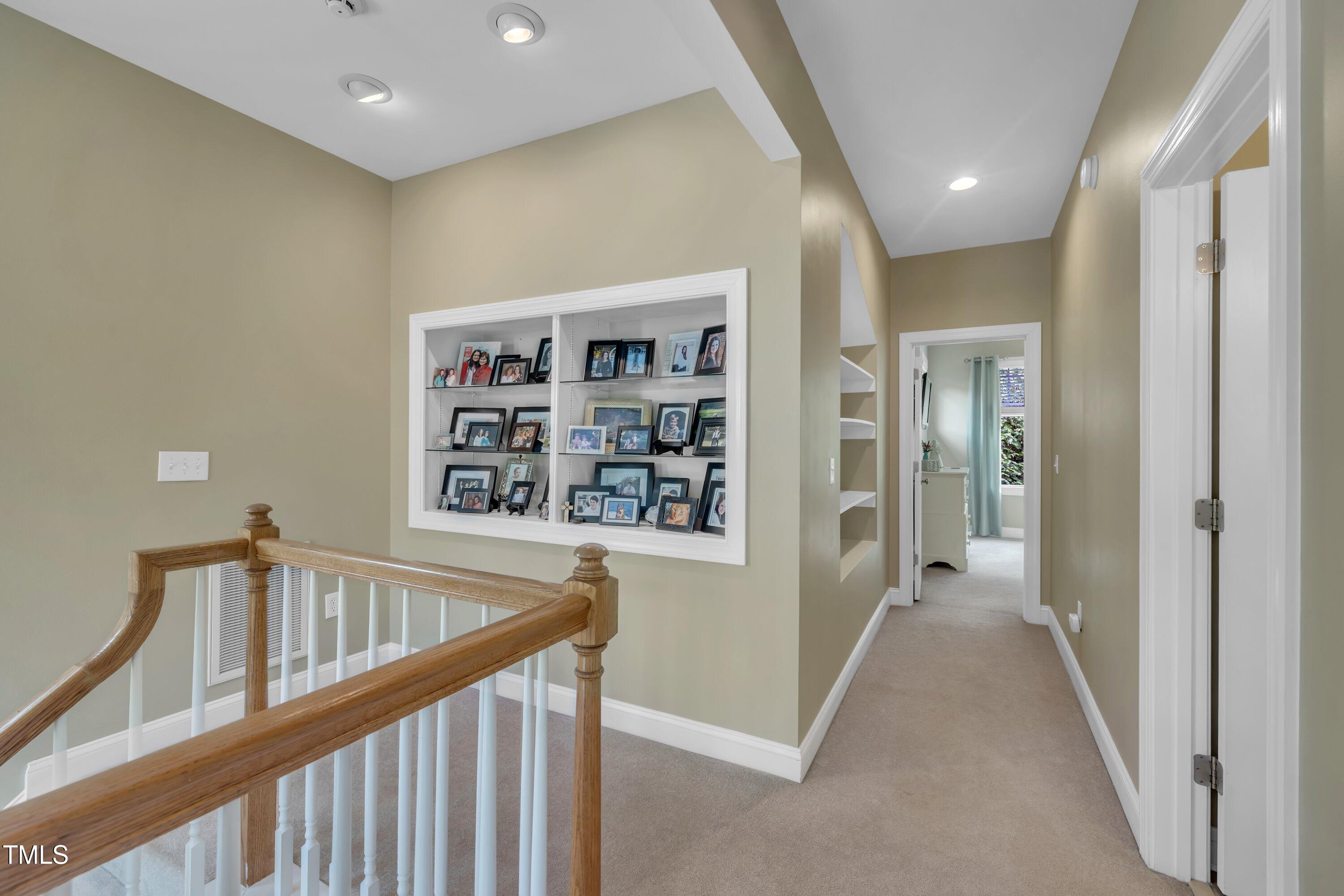 4802 Glenmist Court Raleigh, NC 27612 - Photo 28 of 52 a view of a hallway with wooden floor and staircase