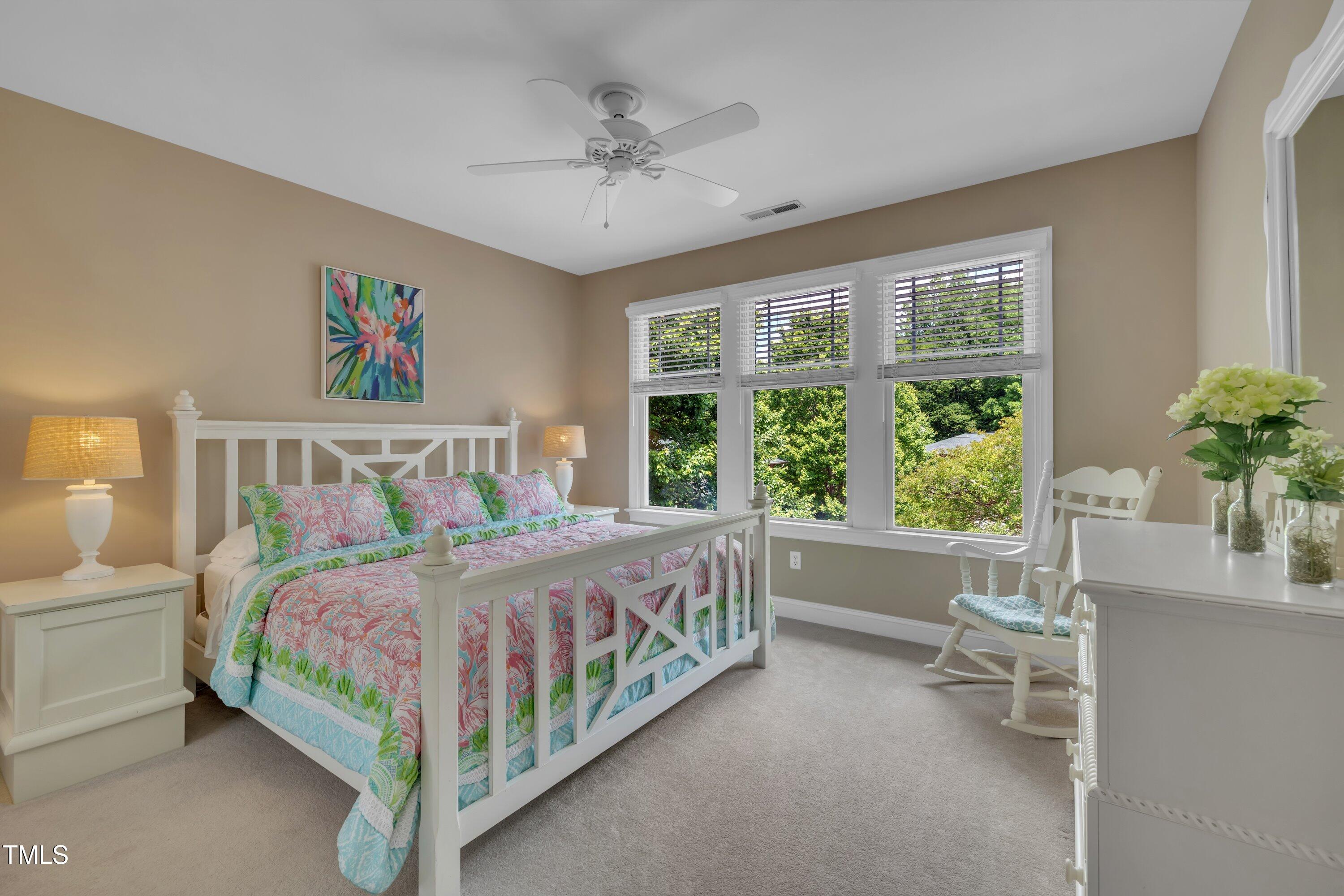 4802 Glenmist Court Raleigh, NC 27612 - Photo 29 of 52 a bedroom with a large bed and a chandelier