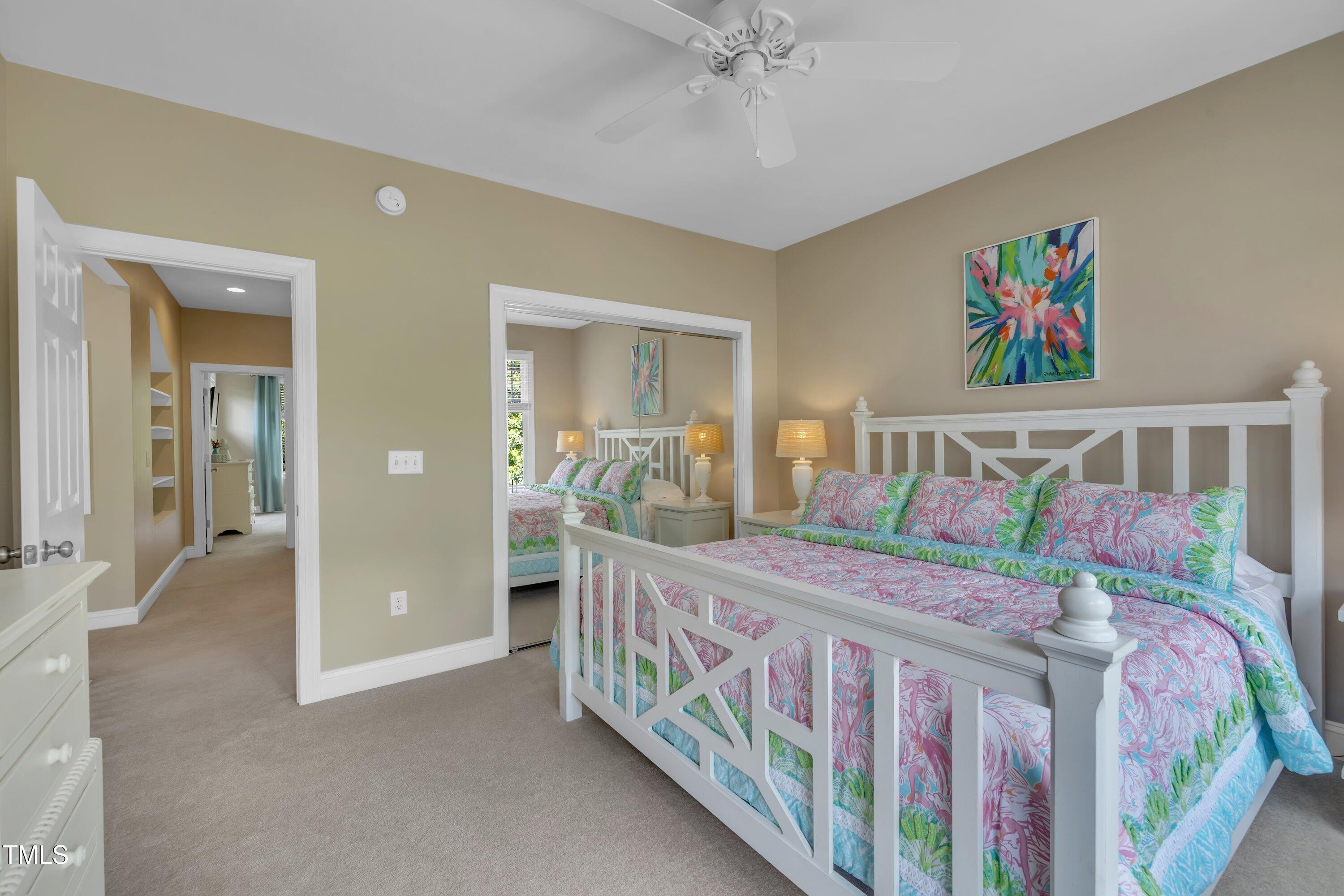 4802 Glenmist Court Raleigh, NC 27612 - Photo 30 of 52 a bedroom with three beds and a chandelier