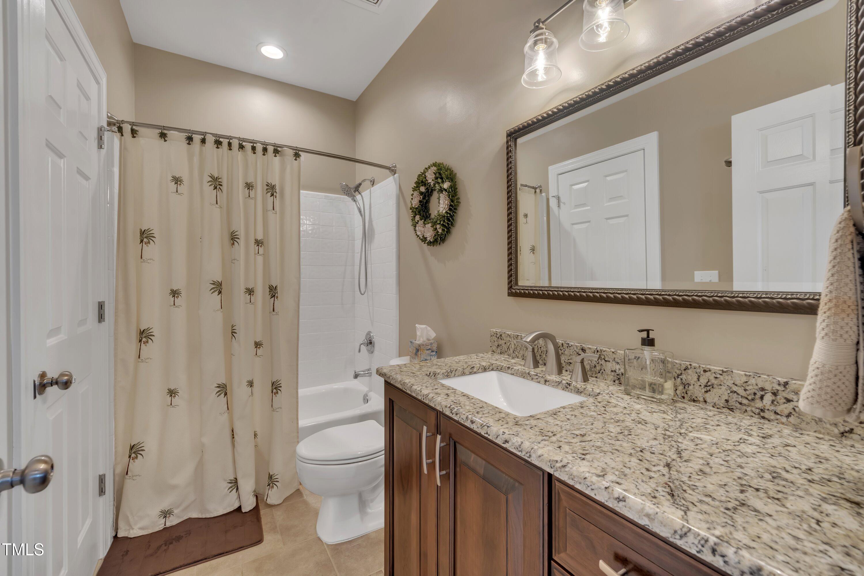 4802 Glenmist Court Raleigh, NC 27612 - Photo 31 of 52 a bathroom with a granite countertop sink toilet and shower
