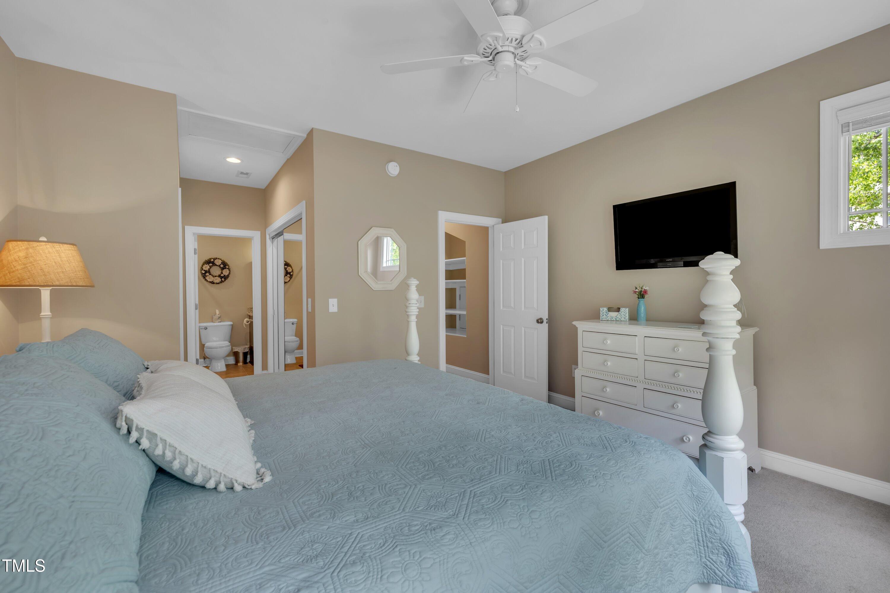 4802 Glenmist Court Raleigh, NC 27612 - Photo 33 of 52 a bedroom with furniture and a flat screen tv