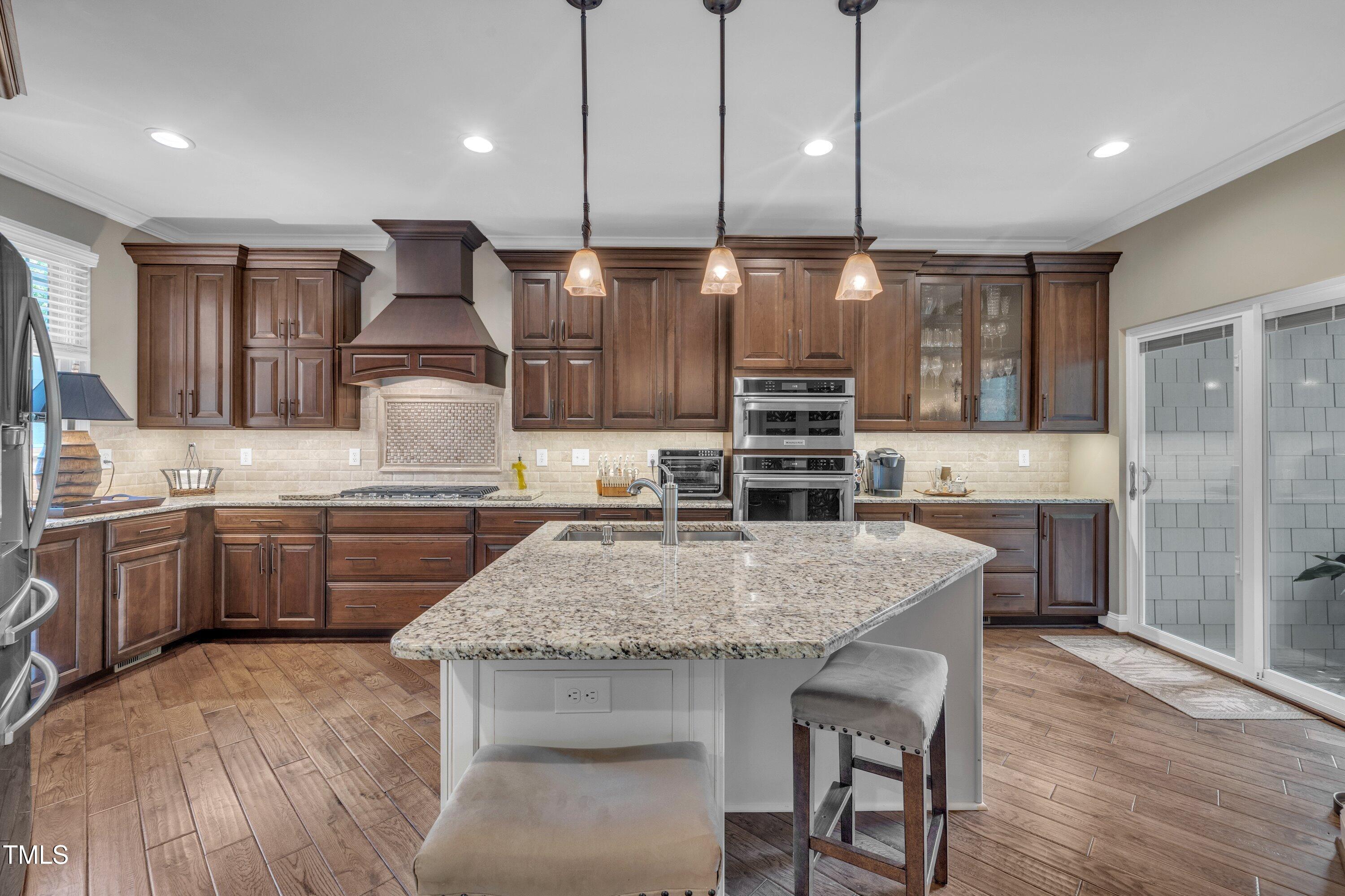 4802 Glenmist Court Raleigh, NC 27612 - Photo 9 of 52 a kitchen with stainless steel appliances granite countertop a kitchen island hardwood floor sink and stove