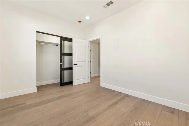 an empty room with wooden floor