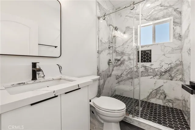 a bathroom with a sink toilet and shower
