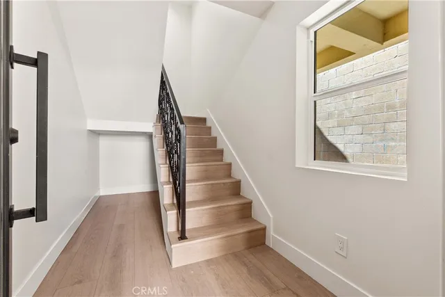 a view of staircase with white walls and a window