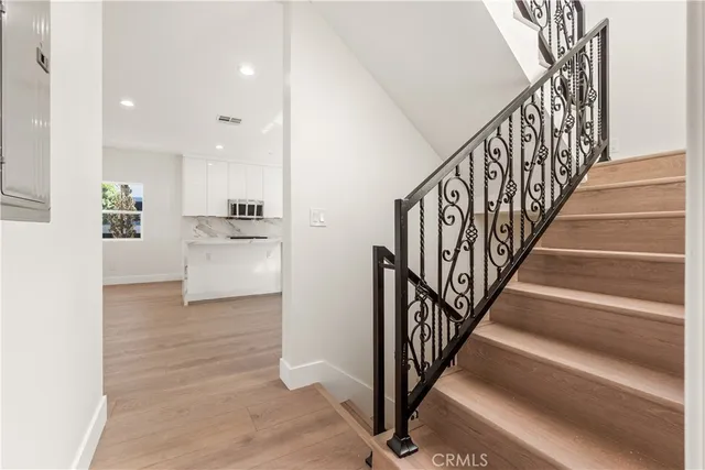 a view of entryway and hall with wooden floor