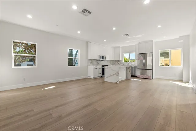 a view of kitchen with furniture and wooden floor