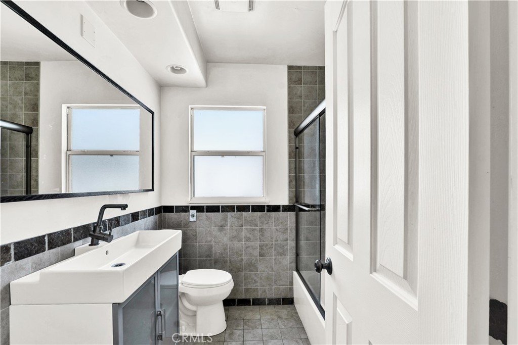 8048 Etiwanda Avenue Reseda, CA 91335 - Photo 12 of 16 a bathroom with a toilet sink and mirror