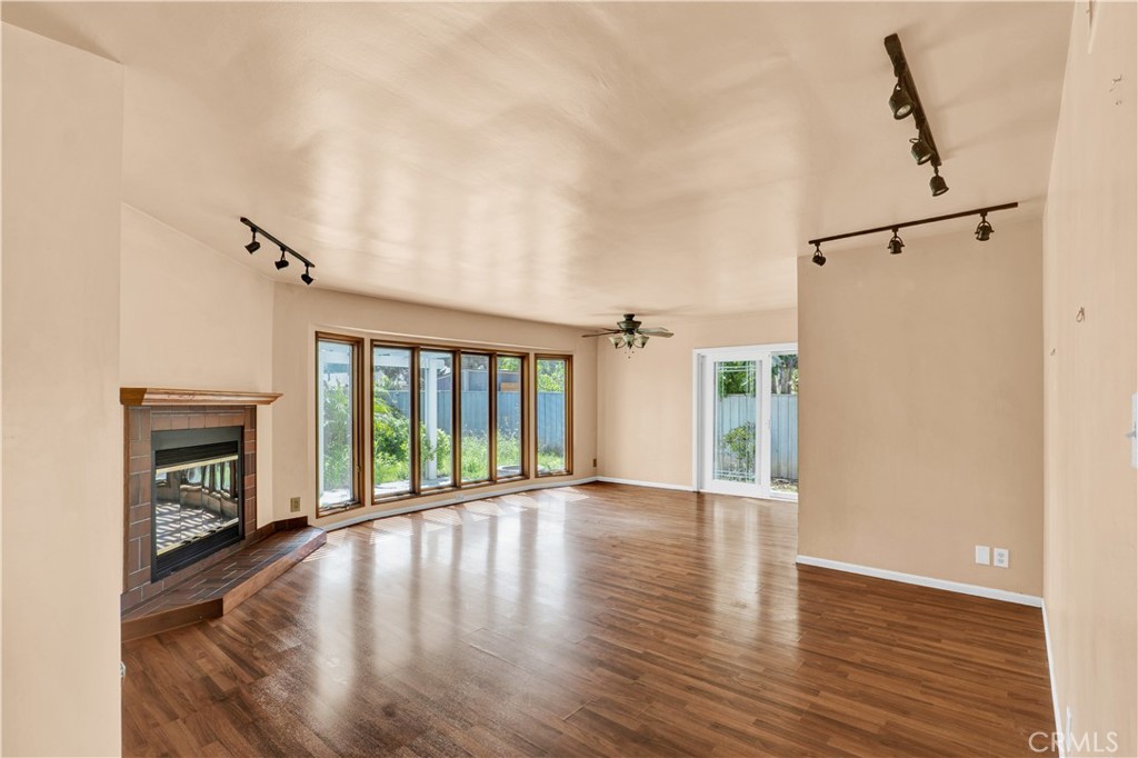 8048 Etiwanda Avenue Reseda, CA 91335 - Photo 2 of 16 a view of an empty room with wooden floor and a window