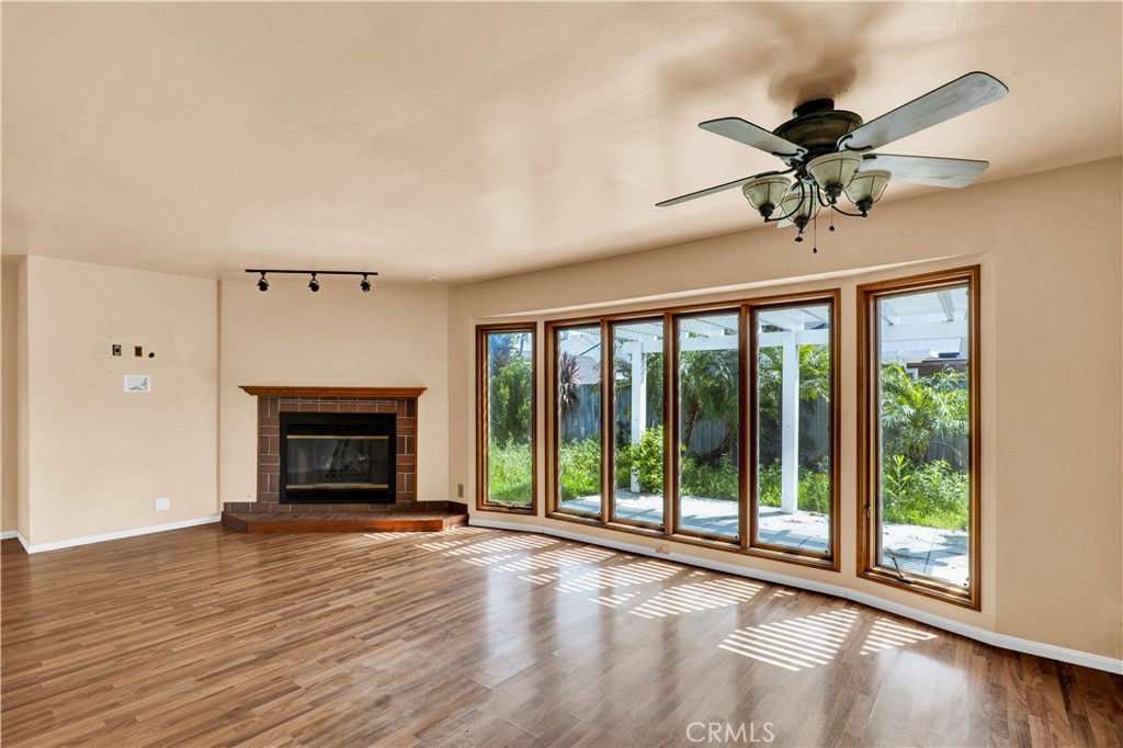 8048 Etiwanda Avenue Reseda, CA 91335 - Photo 4 of 16 a view of an empty room with a fireplace and a window