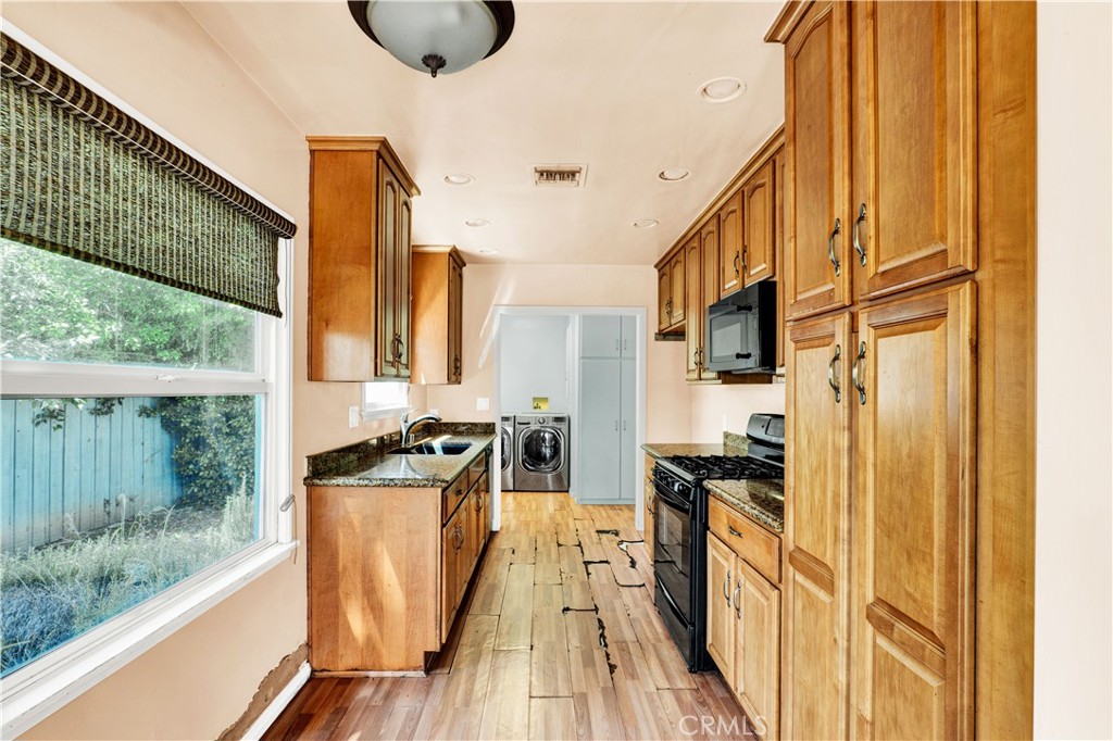 8048 Etiwanda Avenue Reseda, CA 91335 - Photo 7 of 16 a kitchen with stainless steel appliances a stove top oven