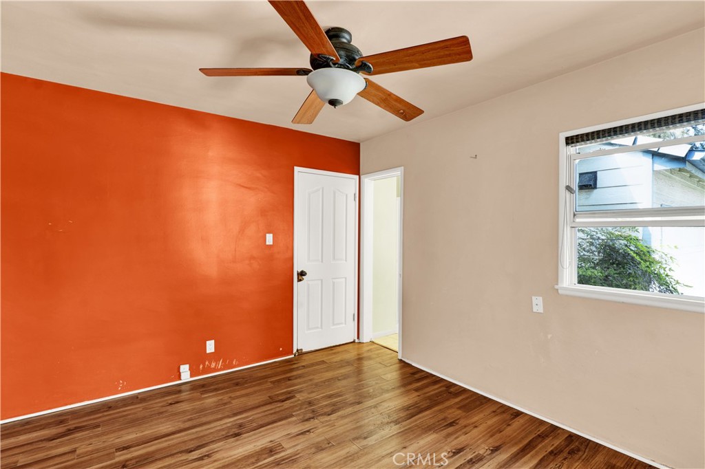 8048 Etiwanda Avenue Reseda, CA 91335 - Photo 9 of 16 an empty room with wooden floor and windows
