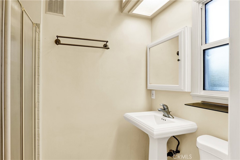 8048 Etiwanda Avenue Reseda, CA 91335 - Photo 10 of 16 a bathroom with a sink a toilet and mirror