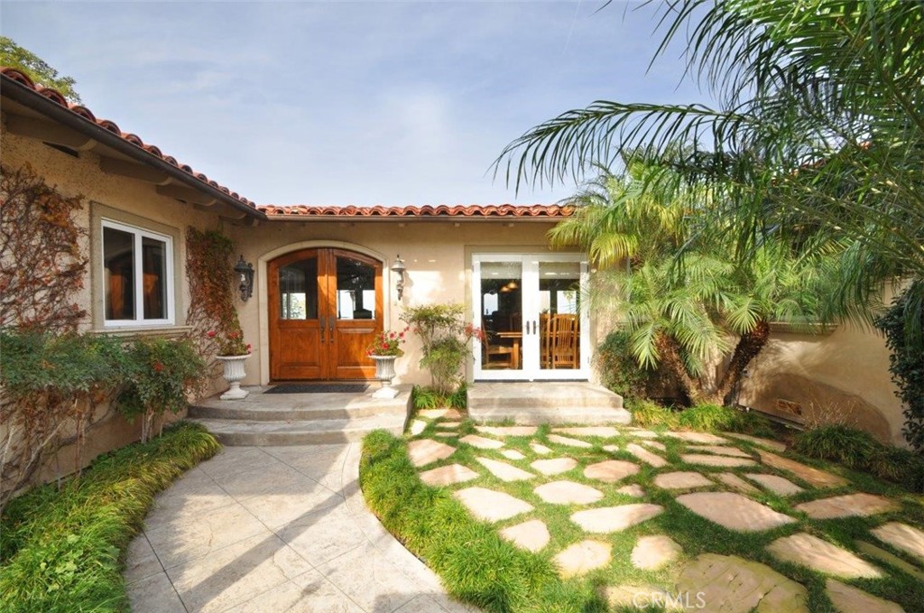 1525 Chelsea Road Palos Verdes Estates, CA 90274 - Photo 3 of 29 a front view of a house with a garden