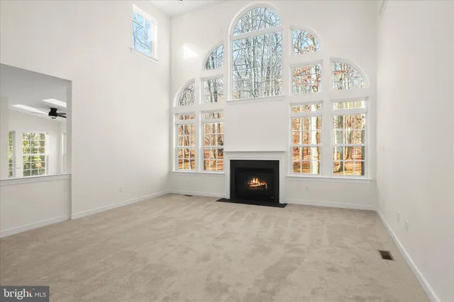 a kitchen with granite countertop white cabinets and stainless steel appliances